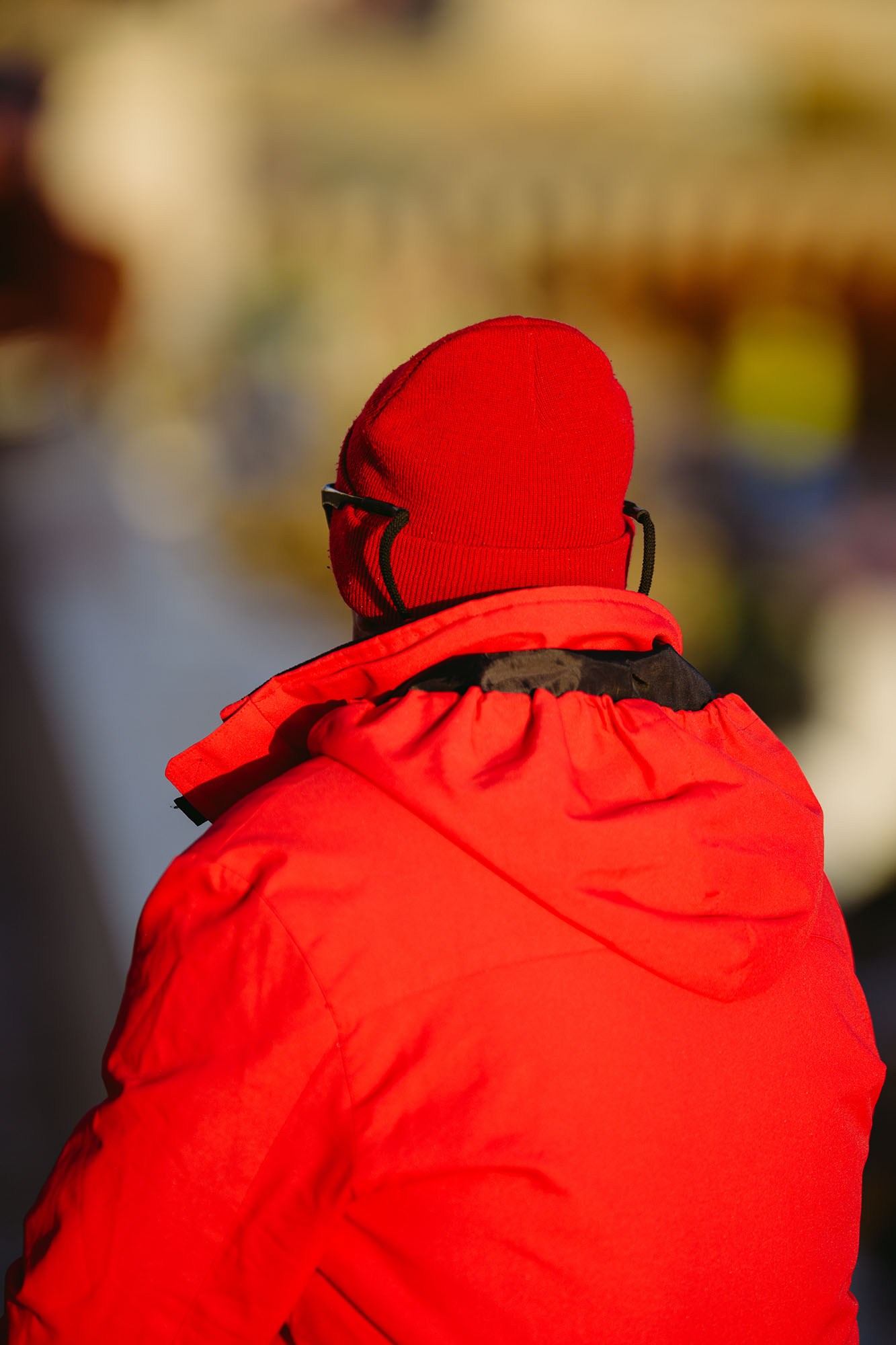 Man in red wearing winter clothes in central Lisbon, Portugal