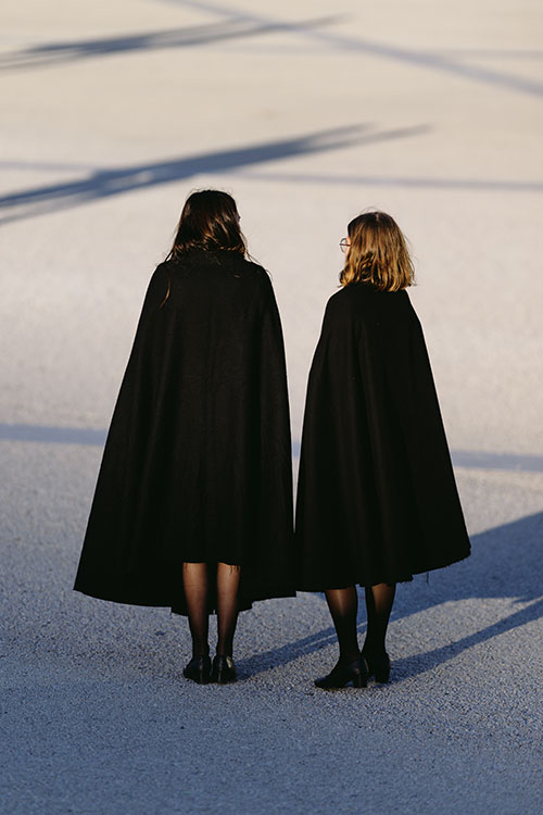 Two girls in black coats at the Praca do Comercio in central Lisbon, Portugal
