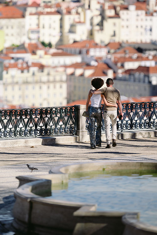 Couple observing the city from viewing point in Principe Real area of Lisbon, Portugal
